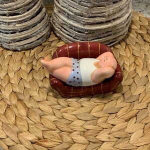 Ceramic Figurine on Red Couch